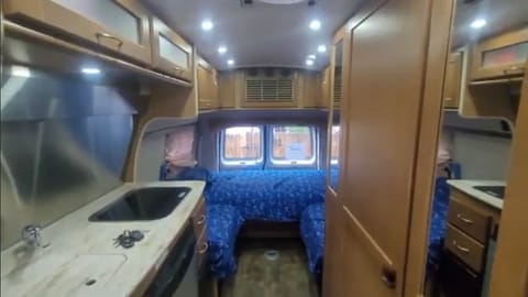 Couch/bed and chairs in back. Couch flattens into Queen bed and can extend into King size