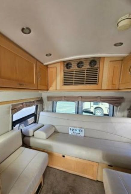 Couch/bed and back lounge seats, storage cabinets, A/C