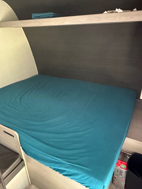 Queen bed with over head storage area… under bed is a large storage area and then small closet area with a rod to hang clothes