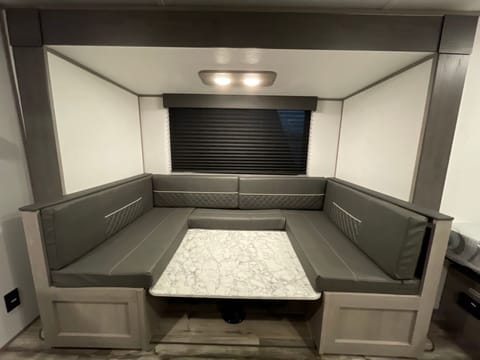 Large dinette to fit everyone for meals, also turns into a bed!