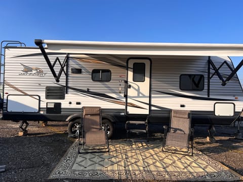 Two outdoor rugs that span the length of the RV.  Two reclining chairs for relaxing outdoors with a tray for your coffee or beer. Front Garage area includes fire pit pie makers and marshmallow sticks. 