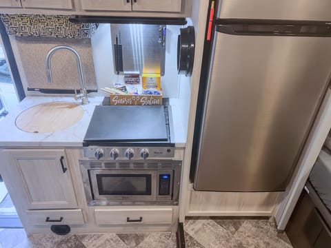 Drawers under the microwave and sink contain all the cooking tools typically needed