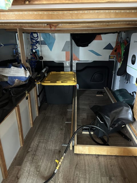 The storage space under the bed is easy to access from the inside of the van