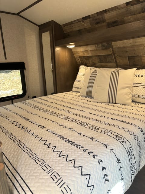 Master bedroom with upgraded Queen mattress and 2 privacy doors. Closet space and nightstands on both sides of the bed.