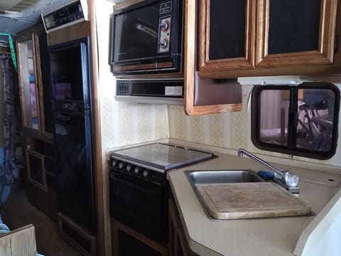 Full kitchen with 4 burner stove, oven, microwave, full size frig, double sink, lots of cabinets. everything you need is here