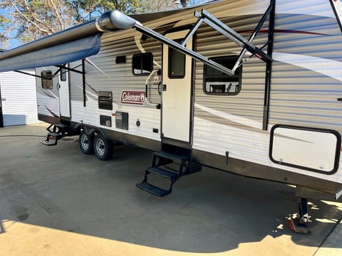 Yard side of the RV with the canopy extended in the lowest position.