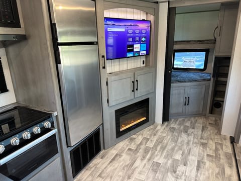 Nice large refrigerator, range with oven, 40" Roku TV, and electric fireplace offer convenience and entertainment to your adventure.