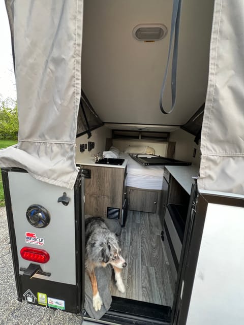 Fridge/freezer on right. Door on bed clips into place when at camp. Nice furnace at foot of bed. 