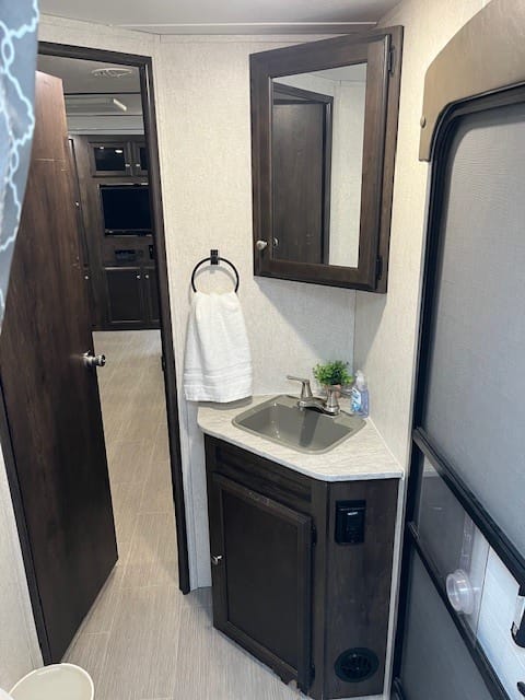 Spacious bathroom with knee room.