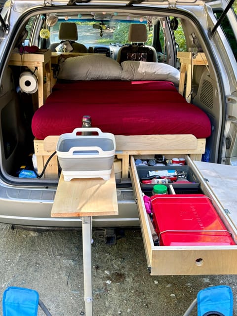 Slide out kitchen with pots and pans, all kitchen essentials , sink , tap , stove , grocery storage etc