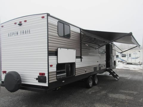 Large awning with a small outside fridge.