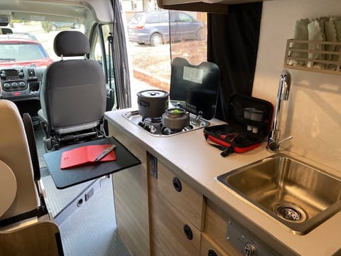 The van stove and sink are easy to access and use, and you'll have access to cookware so you can make meals on the go. The extendable pull-out shelf also adds more prep space for all of your needs.