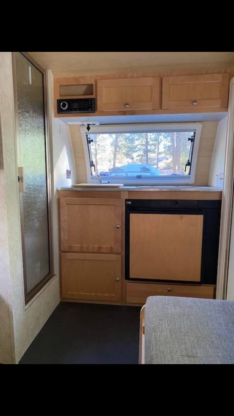 Kitchen galley include a sink (w/freshwater tank), propane cook top, and mini fridge.

It's recommended to NOT cook inside because this is where you will sleep. We usually use the burners to boil water.