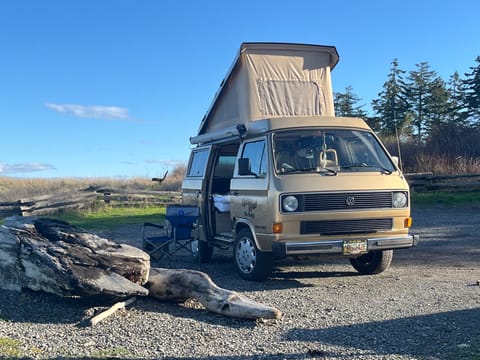 Classic 1985 VW Westfalia “Goldie” parked, with the pop-top open perfect for Vancouver Island road trips and coastal camping.