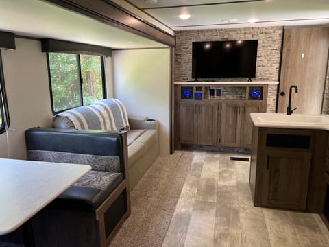 Chill out in the main area sitting in a super comfy love seat that has powered USB ports in the cupholders.  Or break out the puzzle or deck of cards at the kithen table!