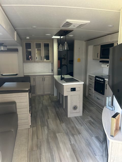 The kitchen and main living space is so roomy! Two slides pop out of this area and the dinette and couch turn into sleeping arrangements.