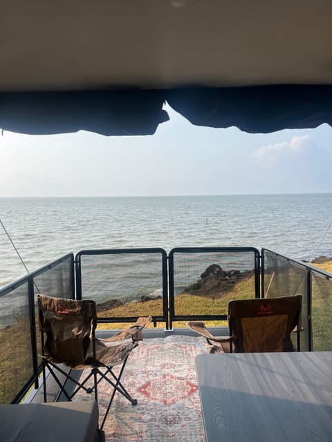 Toy hauler ramp converts into an outdoor patio, looking out from the dining area