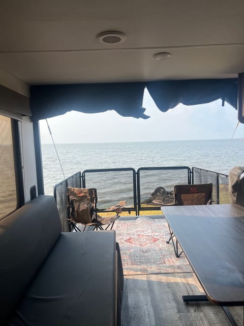 Toy hauler ramp converts into an outdoor patio, looking out from the dining area