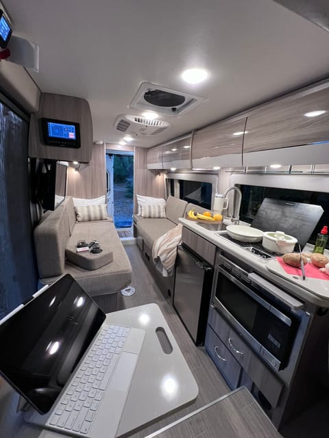 Picture from the passenger seat. Good view of the kitchen also.  Sink, 2 burner stove, microwave and convection over and sink.