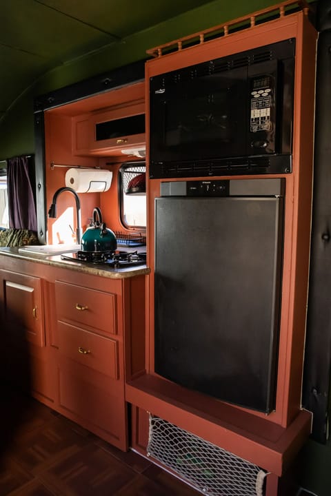 Convection microwave oven, fridge with small freezer compartment, gas stove.