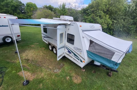 Enjoy our 19 foot camper's extra space with a queen pop-out that extends the length to 23 feet, and the awning which add a whole room outside.