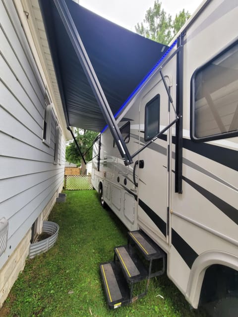 Awning extends farther than pictured, has blue LED light strip which won't attract bugs.