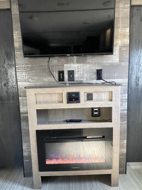 TV, radio with Bluetooth and exterior speakers provide entertainment, while radiant heat “fireplace” keeps things nice and cozy.