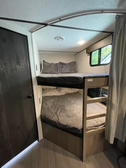 Bigger-than-twin comfortable bunk beds. Privacy curtain, outlets in each, and a window. Have each slept two teenagers.