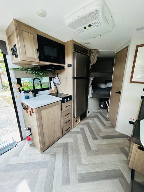 Kitchen area and full size bunks. 