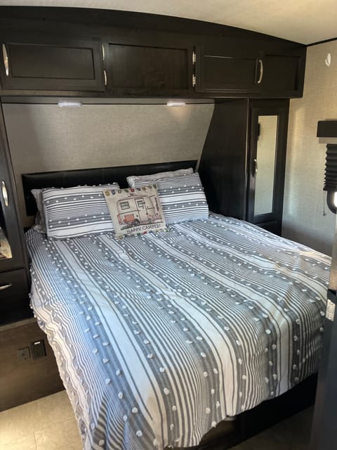 Comfortable Sleeping: The master bedroom  includes a queen-sized bed and ample storage for clothing and personal belongings.