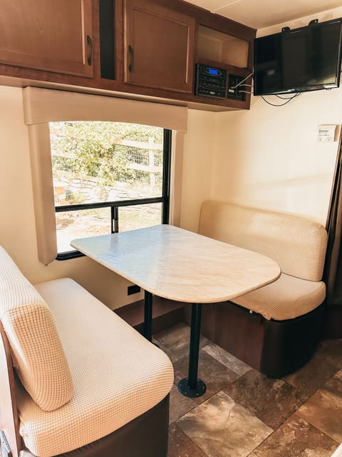 The dining area has great natural light, can turn into a cozy bed, & has great storage under the benches & above. Complete with TV, dvd, cd, & radio.