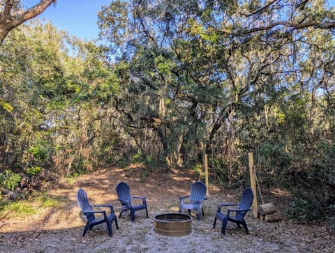 Adirondack chairs around a fire ring