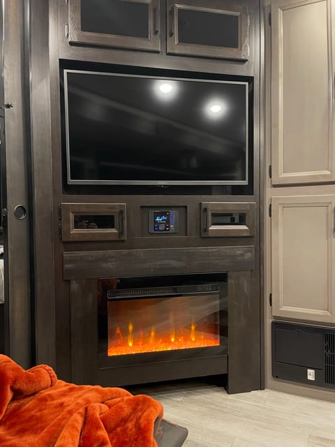 Entertainment  center with cozy fireplace and 2 Lazy boys.