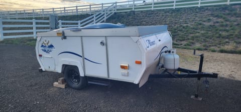 A-liner camper trailer is light and easy to tow with a ball hitch. The top folds down for towing so there is less wind resistance. The propane tank feeds the gas stove and heater.