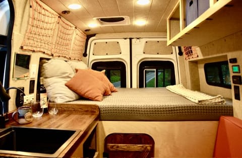 Full-length queen bed with an 8” mattress and built on a permanent platform - we wanted to prioritize and comfortable sleeping space in our vans. 
Rental comes with fresh linens, pillows, and an extra blanket. 