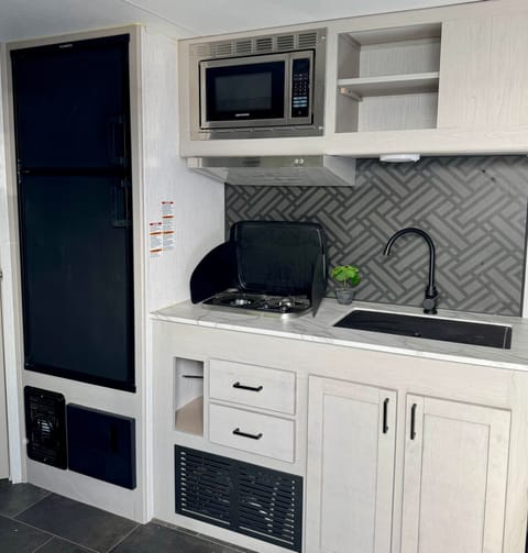 Kitchen area. Pots, pans, silverware, and cooking accessories are all included. 