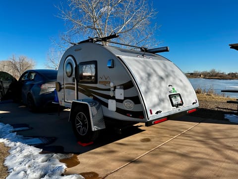 The driver's side of the camper has the city water connection, water tank fill up, exterior shower hose, coax input and 30a electric port.