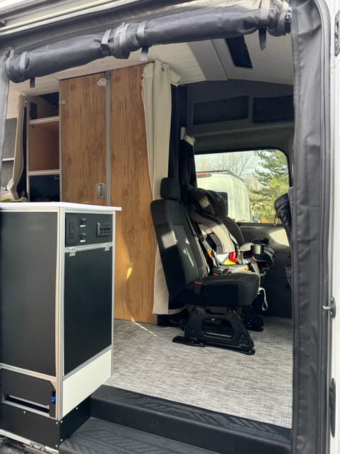 Interior features magnetic bug screen at the entrance. This photo shows the second rows of seats which can be accomodated with child seat if needed
