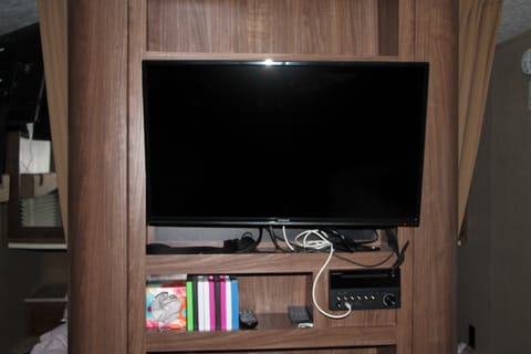 32 in TV connected to the entertainment area. It is connected to the trailer speakers, and DVD player. We can also let you borrow tons of kids DVDs on request for no additional charge!