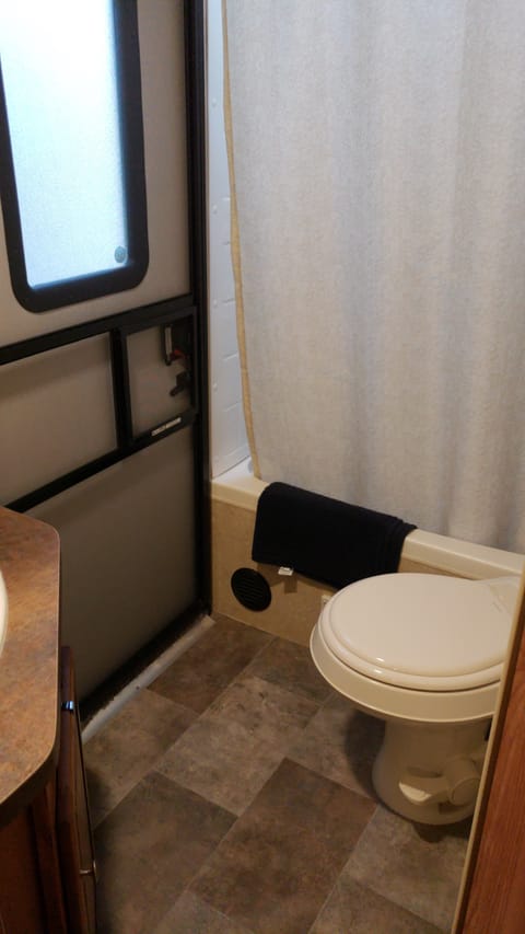 Tub/shower, toilet and sink with rear entry door