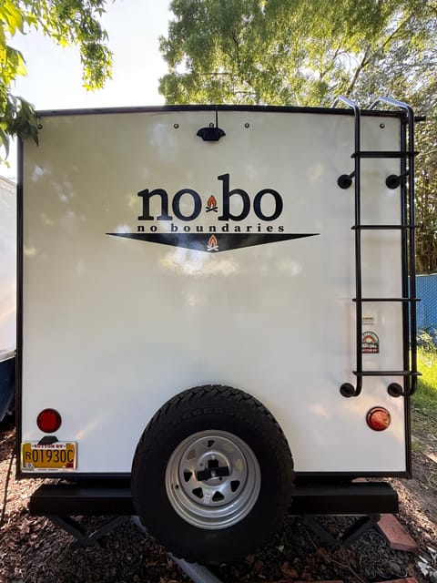 Rear side with ladder rack to kayak and luggage rack area and spare tire.