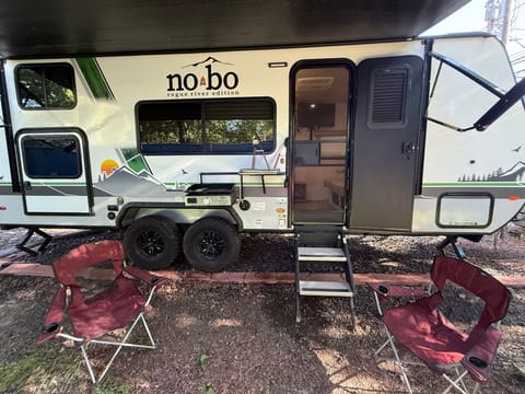 Main ouside awning setup with griddle and chairs.
