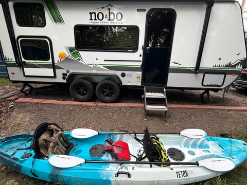 Fully loaded tandem kayak with three life vests and paddles.