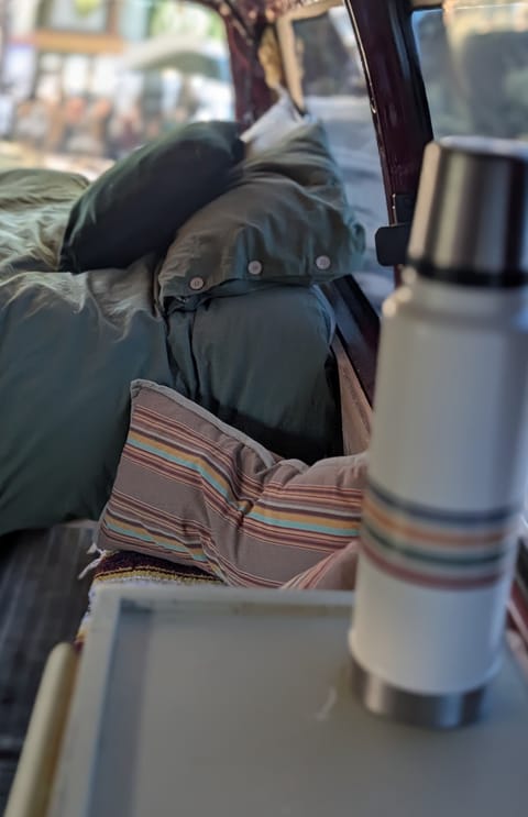 Bed with a storage cabinet/bench next to it