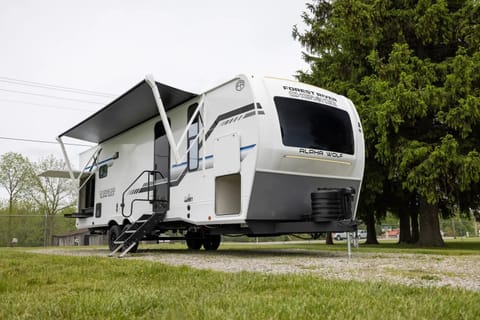 the Alpha Wolf 25RB by Forest River is highlighted by a spacious rear bathroom that has plenty of storage. The kitchen is well thought out and features a hidden pantry, 12-volt refrigerator, farm style sink, oven and microwave. The dinette doubles as an extra bed when not in use and provides good seating space along with the theatre seats in the living area. Relax in the bedroom with a queen size bed, ample wardrobe space and a laundry chute.