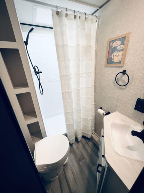 Shower and toilet in bathroom.