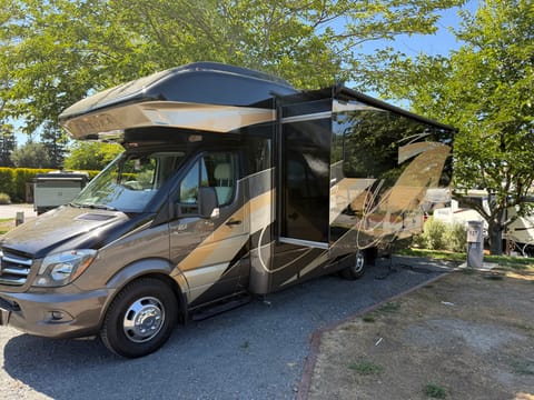 The driver side slide is almost the full length of the RV. Makes it easy to drive when closed, but lots of interior room when open. 