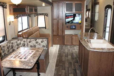 Dinette with pull out couch. Kitchen island and swivel mounted TV.
