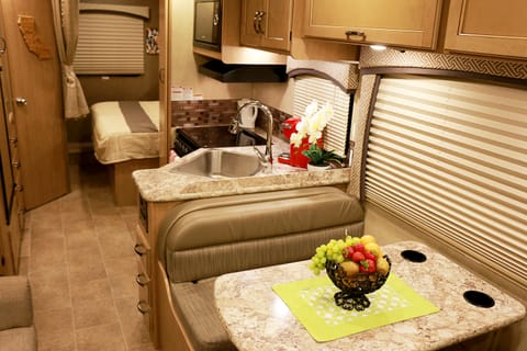 Interior showing dinette, kitchen and bed