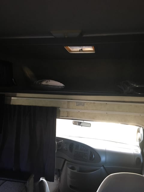 Top bunk (sleeps 2) above driver's and passenger's seat